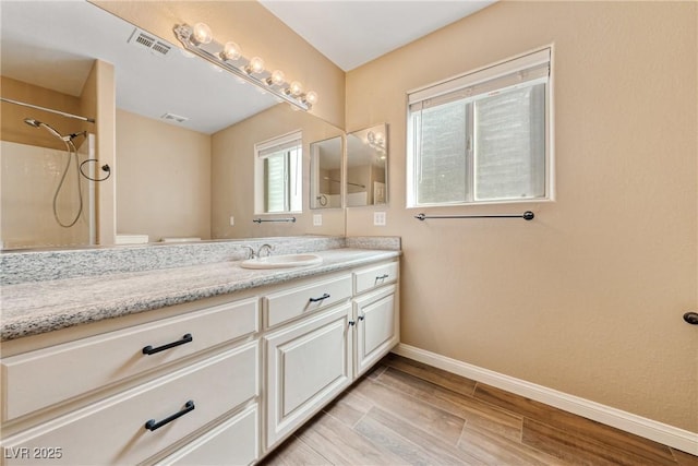 2681 Underbrush Ave, Pahrump, NV 89048 - full bathroom with baseboards, vanity, wood finished floors, and visible vents