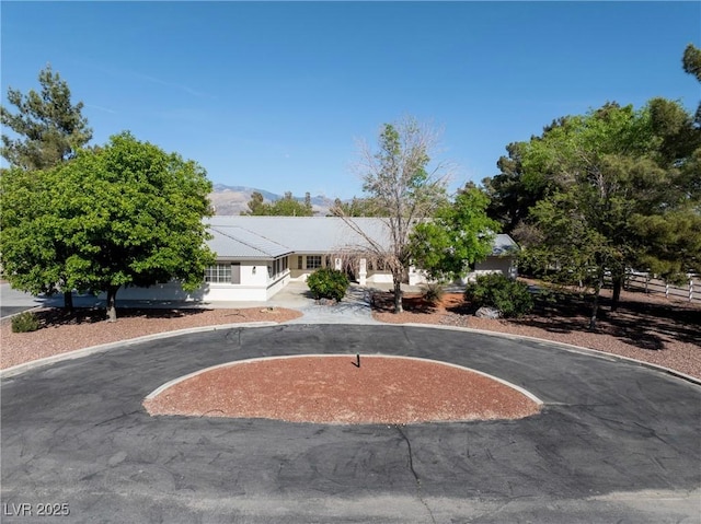2681 Underbrush Ave, Pahrump, NV 89048 - view of front facade featuring fence and curved driveway
