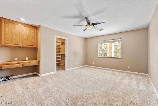 2681 Underbrush Ave, Pahrump, NV 89048 - spare room featuring visible vents, baseboards, light colored carpet, and ceiling fan
