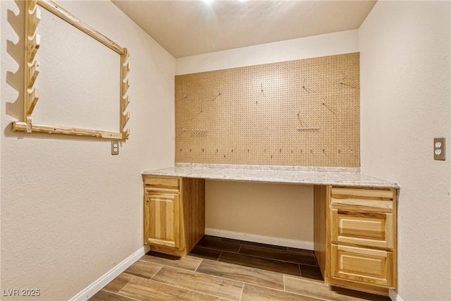 2681 Underbrush Ave, Pahrump, NV 89048 - interior space featuring wood tiled floor, built in study area, and baseboards