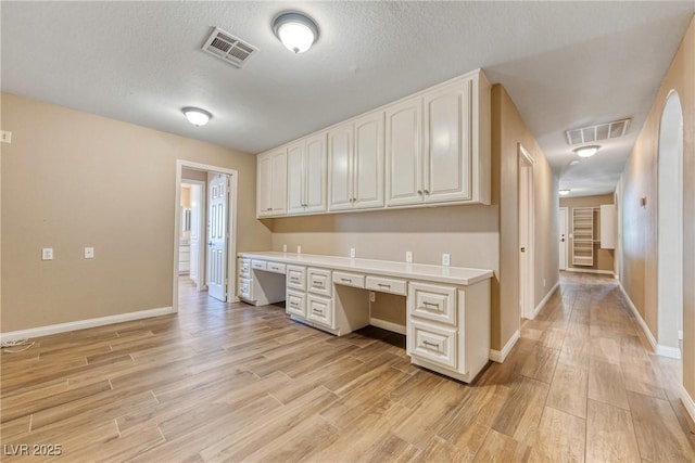 2681 Underbrush Ave, Pahrump, NV 89048 - unfurnished office with built in desk, light wood-style floors, visible vents, and baseboards