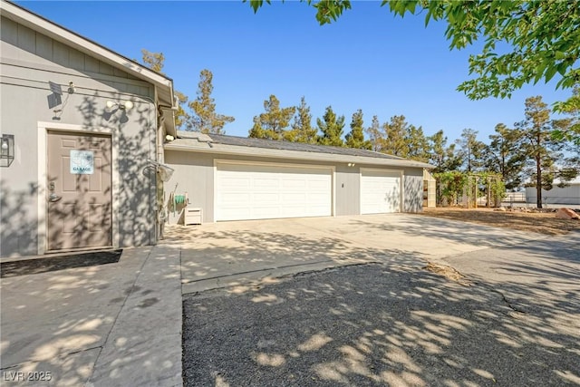 2681 Underbrush Ave, Pahrump, NV 89048 - view of home's exterior with concrete driveway, an attached garage, and stucco siding