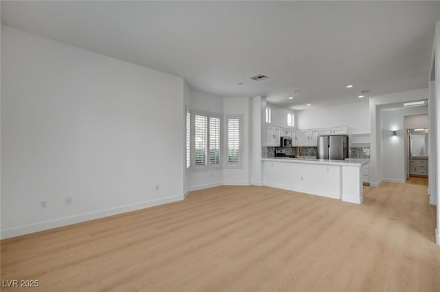 2721 Faiss Dr, Las Vegas, NV 89134 - unfurnished living room with light wood-style floors, baseboards, and recessed lighting