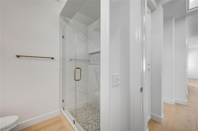 2721 Faiss Dr, Las Vegas, NV 89134 - bathroom featuring toilet, a marble finish shower, wood finished floors, and baseboards