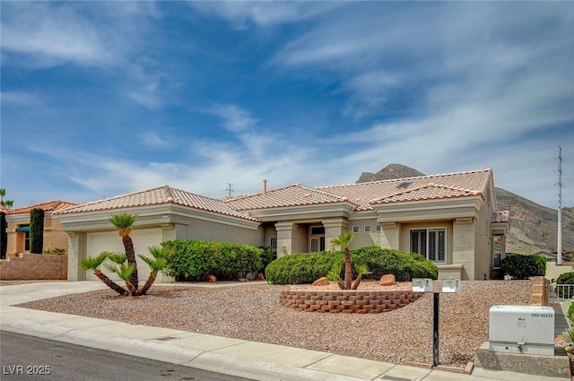 2721 Faiss Dr, Las Vegas, NV 89134 - view of front of property featuring a tiled roof, concrete driveway, an attached garage, and stucco siding