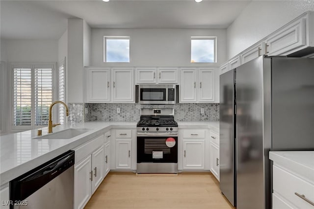 2721 Faiss Dr, Las Vegas, NV 89134 - kitchen with appliances with stainless steel finishes, a sink, white cabinetry, healthy amount of natural light, and recessed lighting