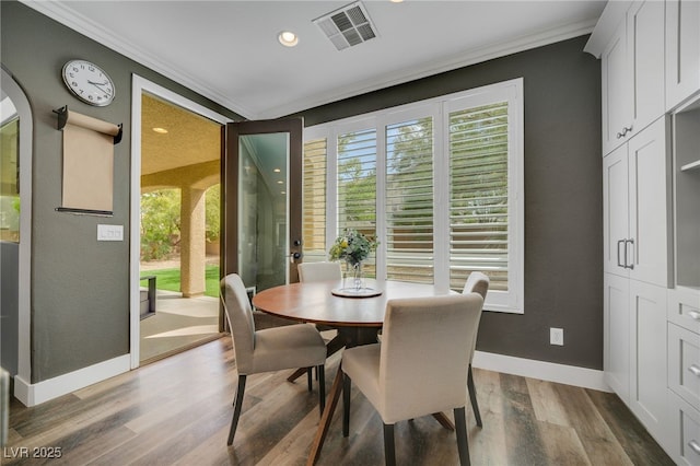 8537 Eureka Heights Ct, Las Vegas, NV 89178 - dining room with ornamental molding, plenty of natural light, baseboards, wood finished floors, and recessed lighting