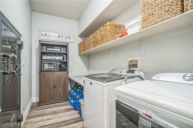 8537 Eureka Heights Ct, Las Vegas, NV 89178 - laundry room with washer and dryer and light wood-style flooring