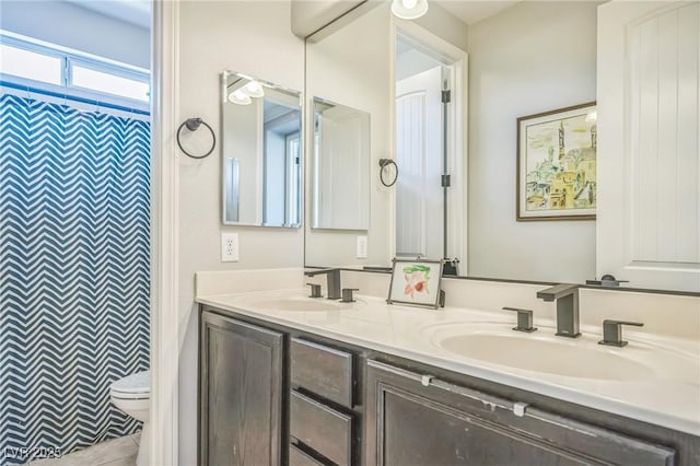 8537 Eureka Heights Ct, Las Vegas, NV 89178 - full bathroom featuring double vanity, toilet, and curtained shower