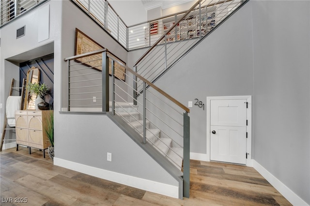 8537 Eureka Heights Ct, Las Vegas, NV 89178 - stairway featuring a high ceiling, baseboards, and wood finished floors