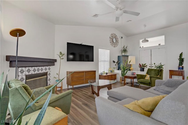 1830 Ginger Blossom Ave, North Las Vegas, NV 89031 - living area with ceiling fan, wood finished floors, vaulted ceiling, and a tiled fireplace