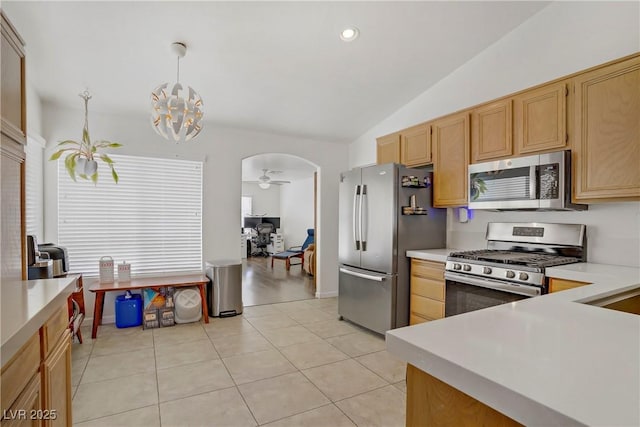 1830 Ginger Blossom Ave, North Las Vegas, NV 89031 - kitchen with appliances with stainless steel finishes, lofted ceiling, arched walkways, light countertops, and light tile patterned floors