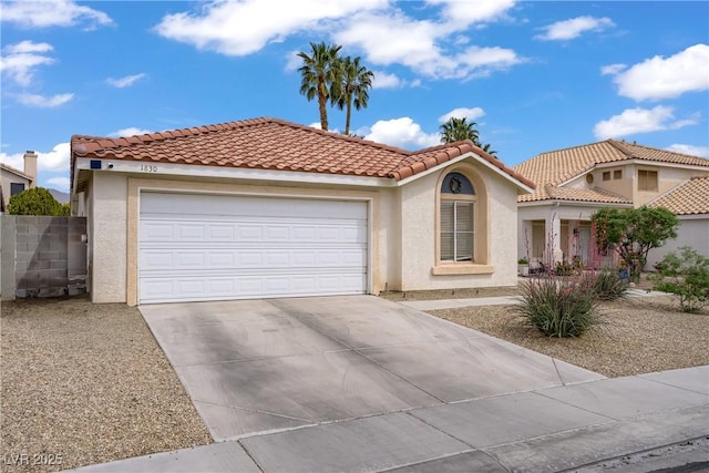 1830 Ginger Blossom Ave, North Las Vegas, NV 89031 - mediterranean / spanish-style home featuring driveway, stucco siding, a garage, and a tile roof