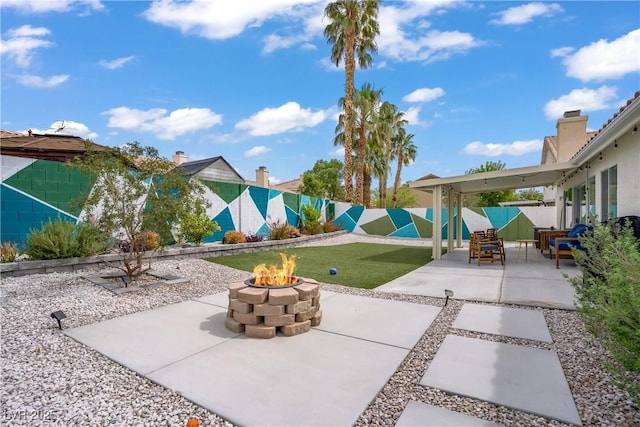1830 Ginger Blossom Ave, North Las Vegas, NV 89031 - fenced backyard with a patio and a fire pit