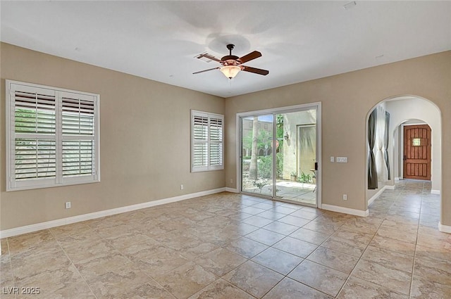 519 Via Garofano Ave, Henderson, NV 89011 - spare room with arched walkways, ceiling fan, and baseboards