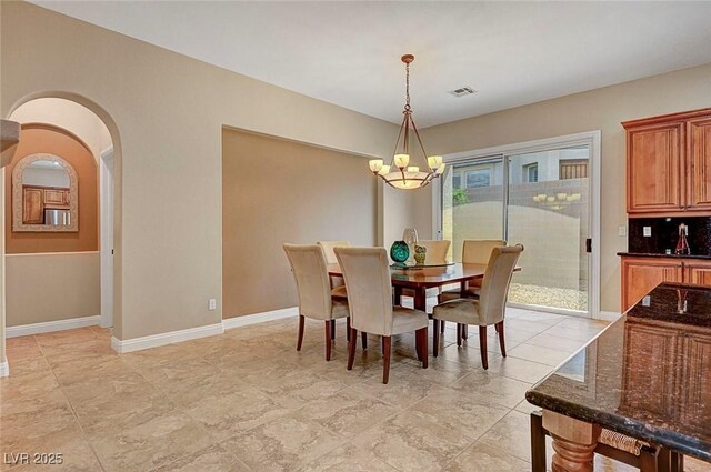 519 Via Garofano Ave, Henderson, NV 89011 - dining area with a chandelier, baseboards, and arched walkways