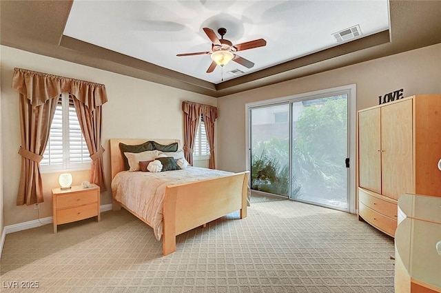 519 Via Garofano Ave, Henderson, NV 89011 - bedroom featuring a tray ceiling, access to outside, light colored carpet, ceiling fan, and baseboards