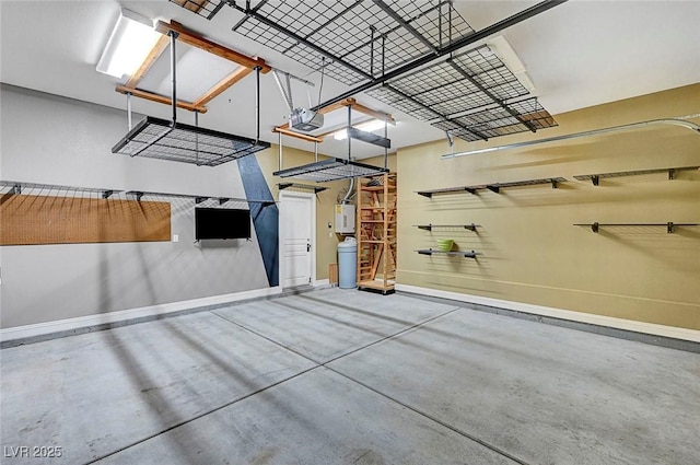 519 Via Garofano Ave, Henderson, NV 89011 - garage with baseboards, a garage door opener, and water heater