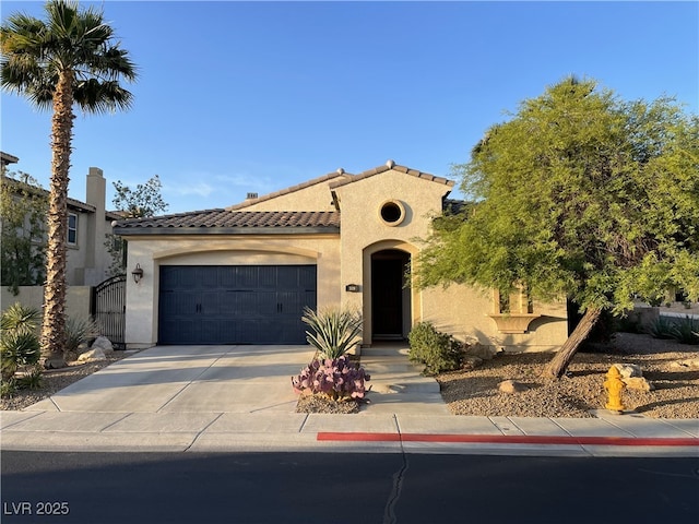 519 Via Garofano Ave, Henderson, NV 89011 - mediterranean / spanish-style house featuring stucco siding, concrete driveway, a tiled roof, and an attached garage