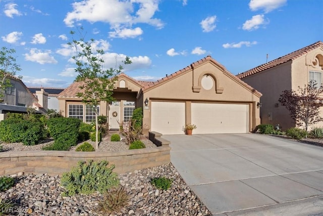 view of front of property featuring an attached garage, driveway, stucco siding, and a tile roof