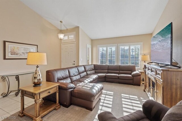 living room featuring light tile patterned flooring and lofted ceiling