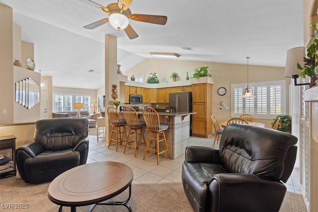 living area featuring visible vents, light tile patterned flooring, a ceiling fan, and lofted ceiling