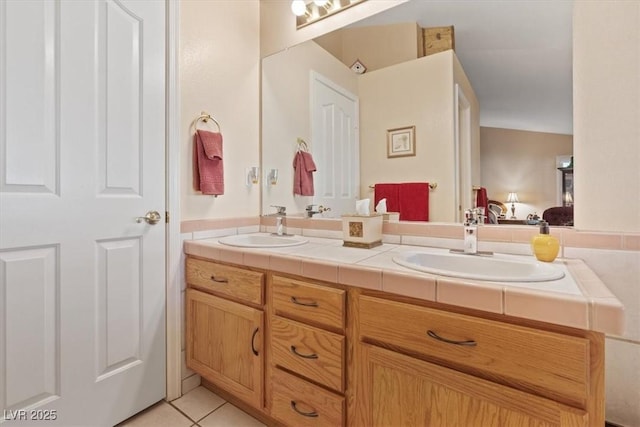 full bathroom with a sink, double vanity, connected bathroom, and tile patterned flooring