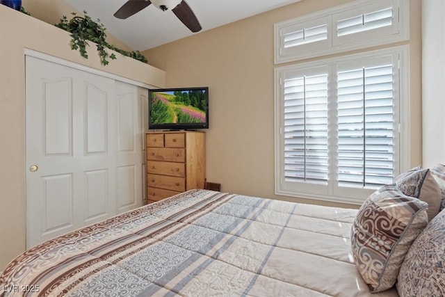 bedroom with a closet, a ceiling fan, and lofted ceiling
