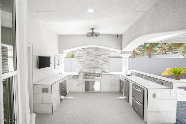 view of patio featuring a grill, fence, a sink, and area for grilling