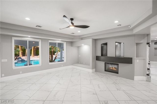 unfurnished living room with ceiling fan, a glass covered fireplace, visible vents, and recessed lighting