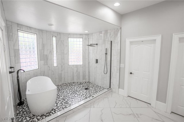 full bathroom featuring marble finish floor, a soaking tub, baseboards, a walk in shower, and recessed lighting