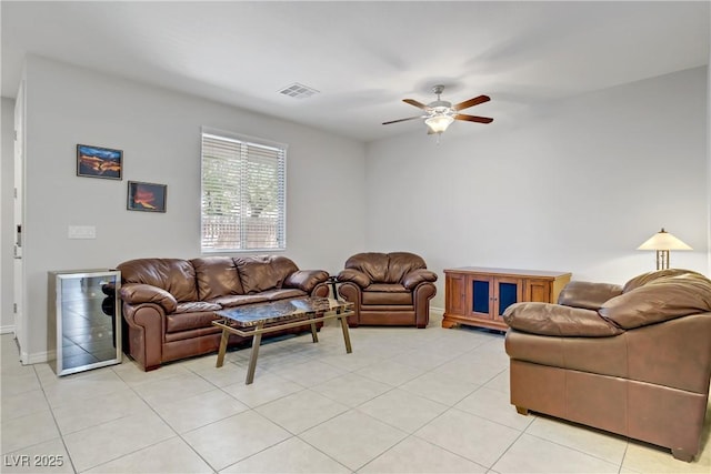 living room with visible vents, light tile patterned flooring, beverage cooler, baseboards, and ceiling fan
