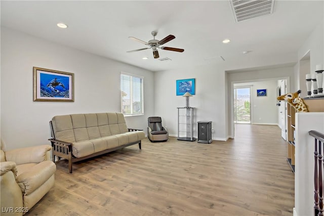 living area featuring ceiling fan, visible vents, a wealth of natural light, and wood finished floors