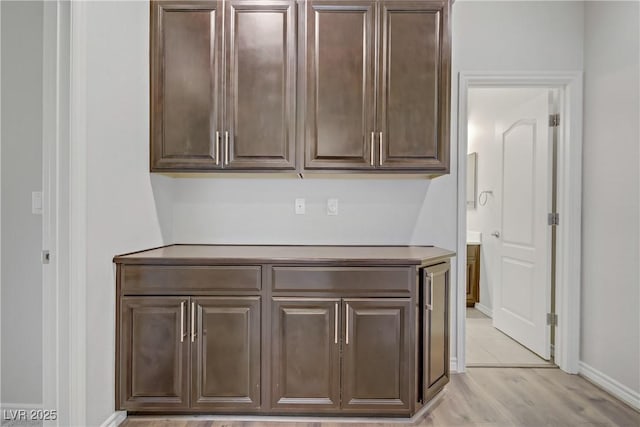 interior space featuring baseboards and light wood-style flooring