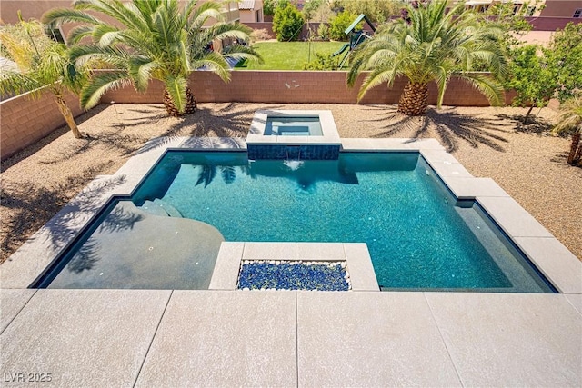 outdoor pool with a fenced backyard and an in ground hot tub