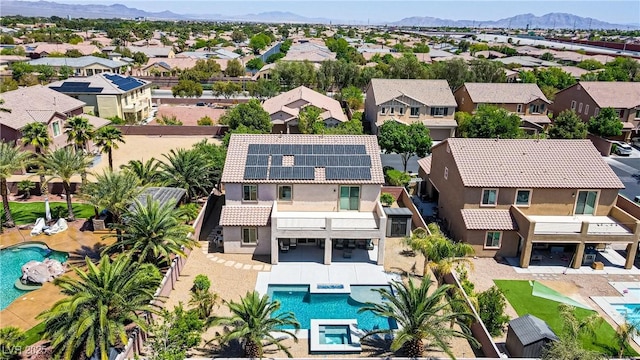 drone / aerial view featuring a residential view and a mountain view
