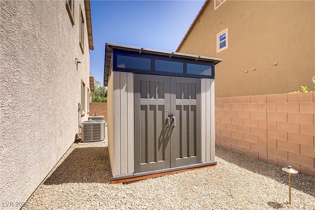 view of shed featuring central AC unit and a fenced backyard