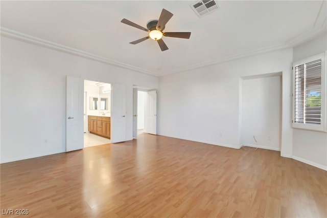 unfurnished room featuring visible vents, ornamental molding, light wood-type flooring, and ceiling fan
