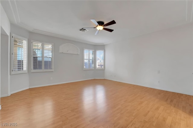empty room featuring light wood-type flooring, baseboards, visible vents, and ceiling fan
