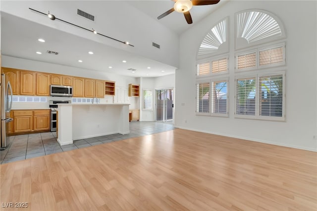 kitchen featuring open shelves, light wood-type flooring, visible vents, and appliances with stainless steel finishes