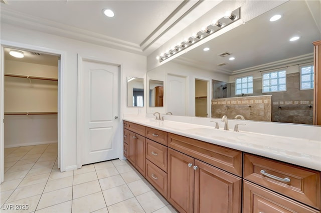 full bath with tile patterned floors, double vanity, visible vents, a sink, and a walk in shower