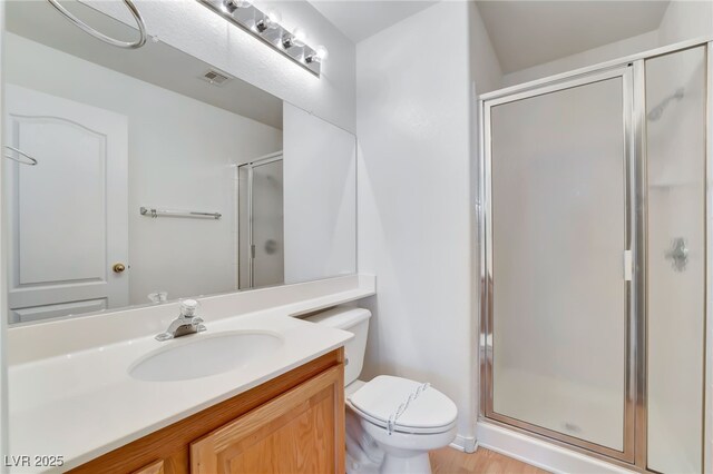 full bath with visible vents, toilet, a stall shower, and vanity