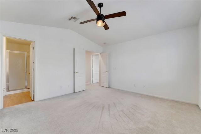 unfurnished bedroom with ceiling fan, carpet floors, ensuite bath, lofted ceiling, and visible vents