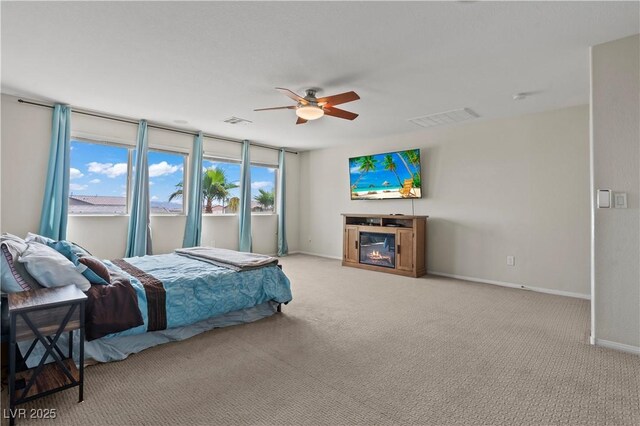 1776 Gentle Brook St, North Las Vegas, NV 89084 - carpeted bedroom with a glass covered fireplace, visible vents, baseboards, and ceiling fan