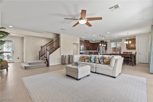 1776 Gentle Brook St, North Las Vegas, NV 89084 - living area featuring ceiling fan with notable chandelier, light tile patterned floors, visible vents, recessed lighting, and stairs