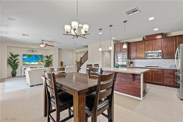 1776 Gentle Brook St, North Las Vegas, NV 89084 - dining room with recessed lighting, visible vents, ceiling fan with notable chandelier, and light tile patterned flooring