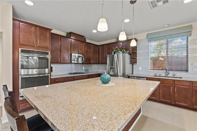 1776 Gentle Brook St, North Las Vegas, NV 89084 - kitchen with a sink, visible vents, backsplash, and appliances with stainless steel finishes