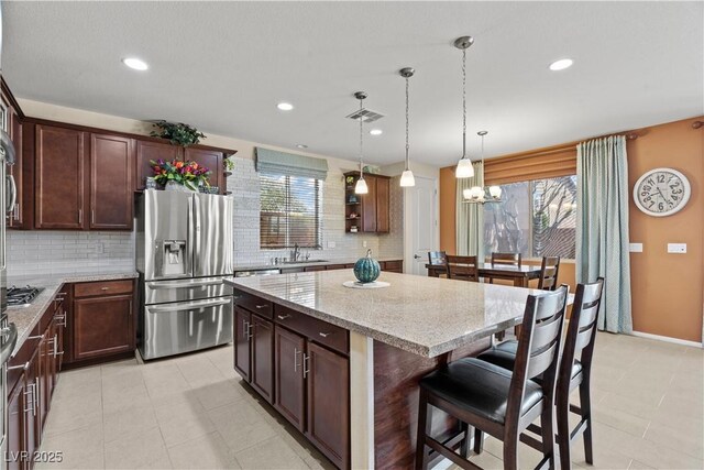 1776 Gentle Brook St, North Las Vegas, NV 89084 - kitchen with stainless steel appliances, tasteful backsplash, visible vents, and a sink