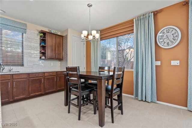 1776 Gentle Brook St, North Las Vegas, NV 89084 - dining room with a notable chandelier and baseboards