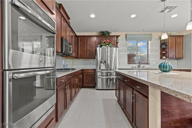 1776 Gentle Brook St, North Las Vegas, NV 89084 - kitchen with tasteful backsplash, visible vents, appliances with stainless steel finishes, and open shelves